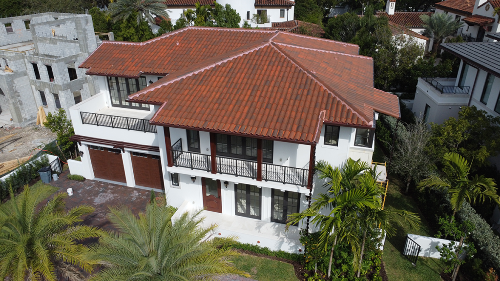 Clay tile roof on a modern residential home under a clear blue sky -roof installations in Florida